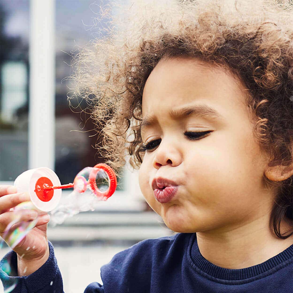 A child blows bubbles.