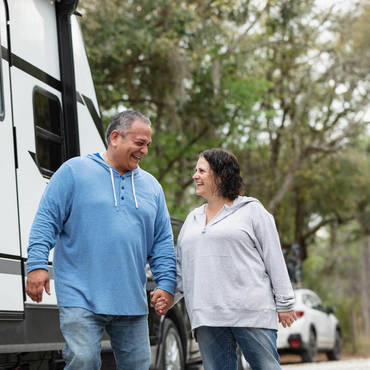 A couple laugh together in a caravan park